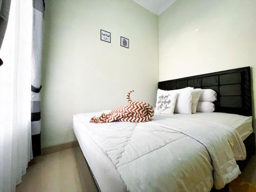 a bedroom with a large white bed in a room at Homestay Kamar Tamu Sedayu in Bantul