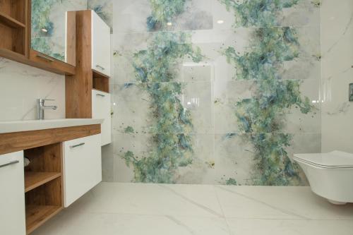 a bathroom with a shower with a blue and green wall at BEACHFRONT WHITE VILLA WİTH PRIVATE SWIMMING POOL in Kalkan