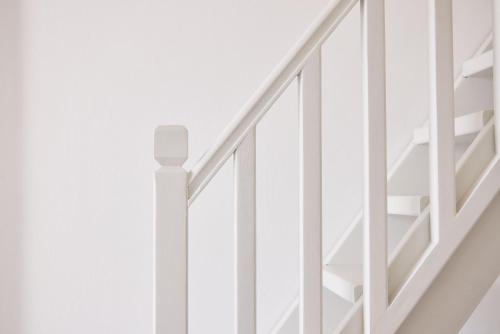 a staircase with white railings in a house at Chrysalis Boutique - Adults Only in Astypalaia Town