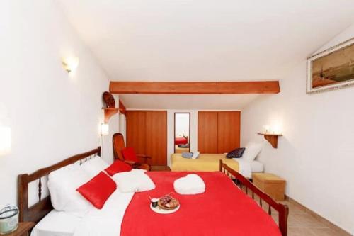 a bedroom with a bed with a red blanket at Villa la Farigoulo in Juan-les-Pins