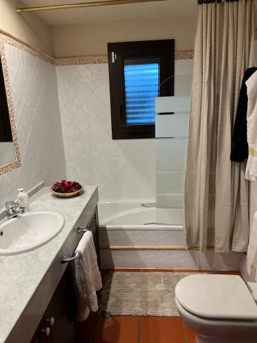 a bathroom with a sink and a toilet and a tub at Villa Sol Luxury Costa Brava Golf in Peralada