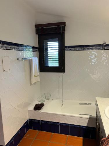 a bathroom with a bath tub and a window at Villa Sol Luxury Costa Brava Golf in Peralada