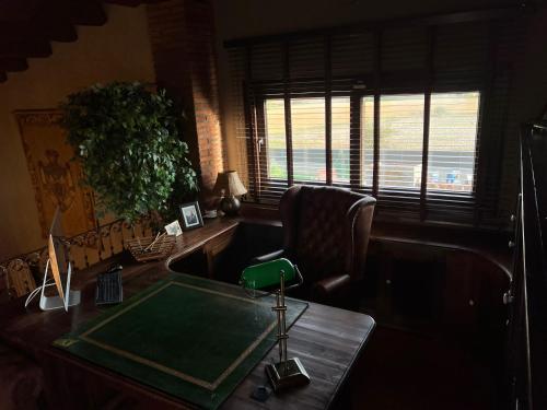 a office with a desk and a chair and a table with a green table at Villa Sol Luxury Costa Brava Golf in Peralada