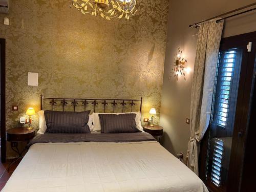 a bedroom with a bed and a chandelier at Villa Sol Luxury Costa Brava Golf in Peralada
