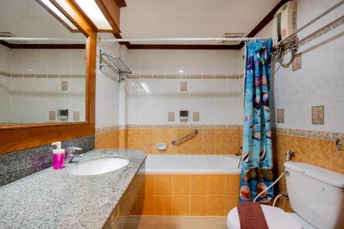 a bathroom with a sink and a tub and a toilet at Lamai Hotel in Patong Beach