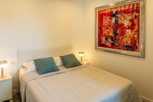 a bedroom with a bed and a painting on the wall at Casas 349h Alicante Centre Second Floor in Alicante