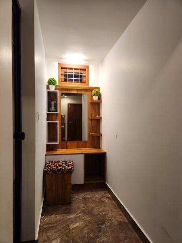 a small room with a counter and a mirror at Bhuvanam homestay in Kalpetta