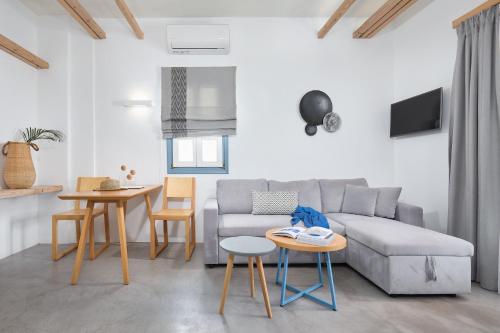 a living room with a couch and a table at Chrysalis Boutique - Adults Only in Astypalaia Town