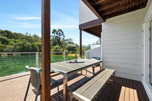 a patio with a table and chairs on a deck at Reflection in Margaret River Town