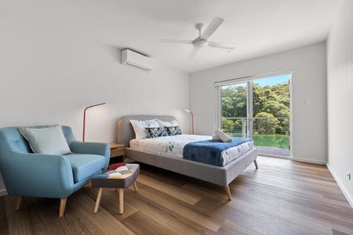 a bedroom with a bed and a chair and a window at Reflection in Margaret River Town