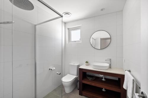 a bathroom with a toilet and a sink and a mirror at Reflection in Margaret River Town