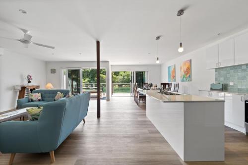 an open kitchen and living room with blue chairs at Reflection in Margaret River Town