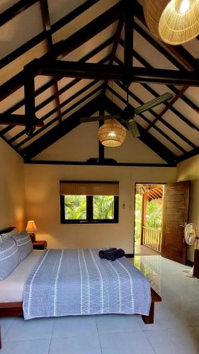 a bedroom with a large bed in a room at Rumah Sunyi in Gili Trawangan