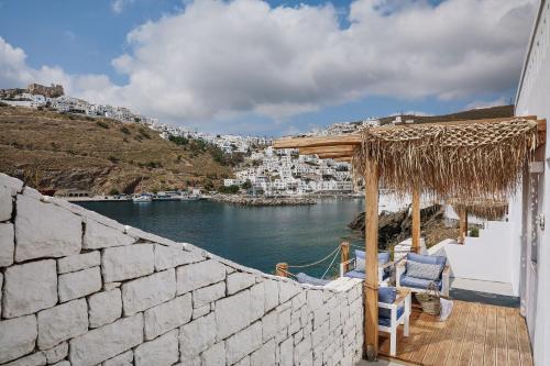 a balcony with chairs and a view of the water at Chrysalis Boutique - Adults Only in Astypalaia Town