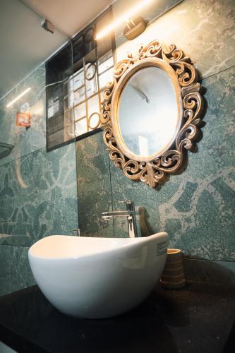 a bathroom with a sink and a mirror on the wall at Nirvana Homestays in Siolim