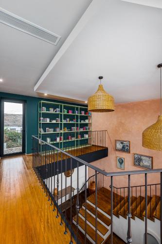 a room with a spiral staircase and green walls at Hameau Mukhrani in Mukhrani