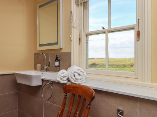 a bathroom with a sink and a window at Faraway Cottage in Penzance