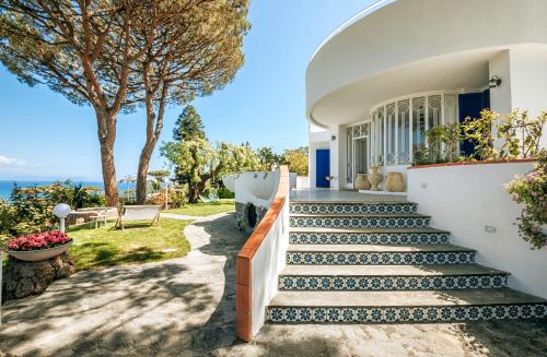 a house with stairs leading up to a house at Villa Livia in Ischia