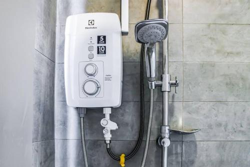 a shower head and a blow dryer on a wall at Near SunwayPyramid 2Bed2Bathroom in Subang Jaya