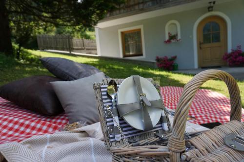 a picnic blanket with a basket on top of it at Ferienwohnung Aignerhof in Schellgaden