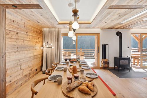 a dining room with a table with bread on it at Chalet Larchwood by Mrs Miggins in Grimentz