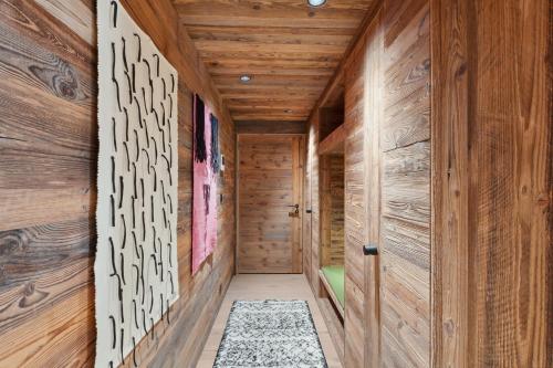 a hallway with wood paneled walls and a wooden floor at Chalet Larchwood by Mrs Miggins in Grimentz
