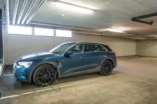 a blue car is being charged in a garage at AlpenParks Hotel & Apartment Carpe Solem Mariapfarr in Mariapfarr