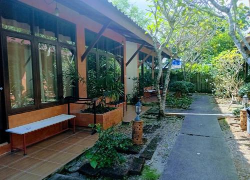 a building with a bench in front of it at Phuket Siam Villas - SHA PLUS in Chalong 