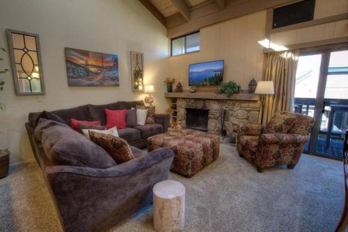 a living room with a couch and chairs and a fireplace at Our Happy Place home in South Lake Tahoe