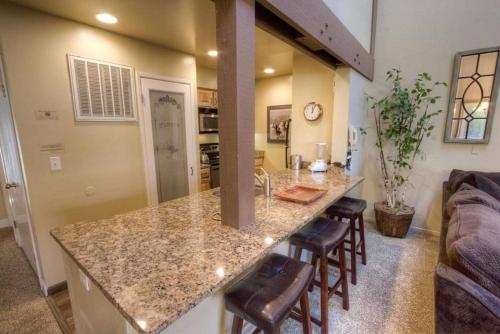 a kitchen with a counter and bar with stools at Our Happy Place home in South Lake Tahoe