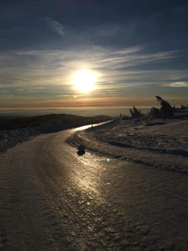 a beach with the sun setting on the horizon at Castrum Visum Wernigerode in Wernigerode