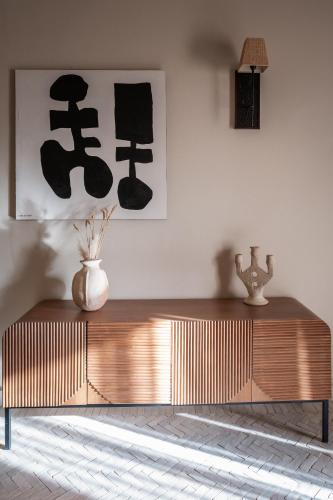 a wooden table in a room with a vase on it at Domaine Des Remparts Hotel & Spa in Marrakech