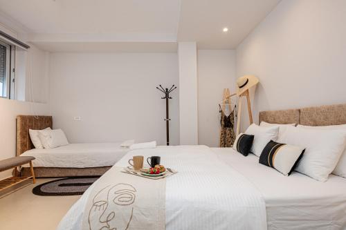 a bedroom with a bed with a tray of food on it at AMINA APARTMENTS in Zakynthos Town
