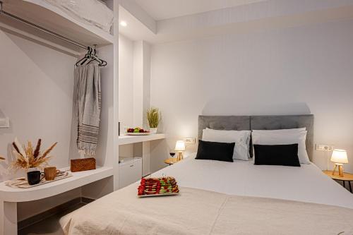 a bedroom with a large bed with a tray of strawberries on it at AMINA APARTMENTS in Zakynthos Town
