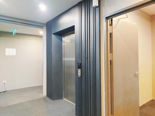a hallway with a glass door in a room at The Leverage Business Hotel - Bandar Baru Mergong in Alor Setar