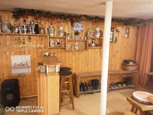 a room with wooden walls with shelves and a counter at Silvester Drevenica pod Horou in Vyšná Korňa