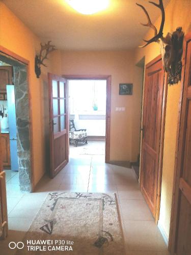 a hallway of a house with an open door at Silvester Drevenica pod Horou in Vyšná Korňa