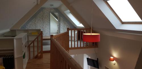 a room with a staircase with a red pendant light at Maison La Petiote 