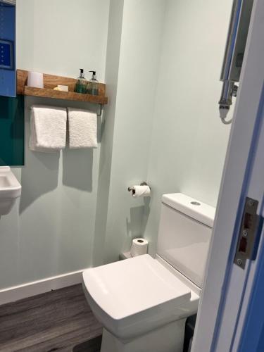 a bathroom with a white toilet and a sink at Killorn Guest House in Oban
