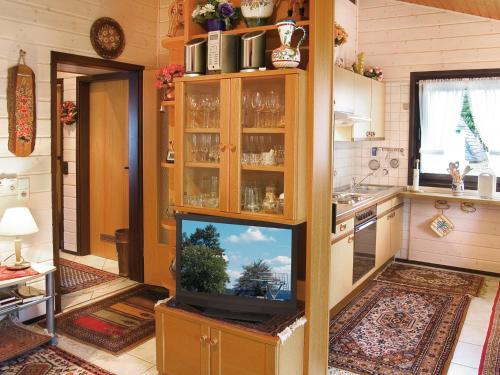 a living room with a tv in a kitchen at Holiday Home Tennenbronn-1 by Interhome in Tennenbronn