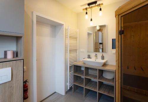 a bathroom with a sink and a mirror at Huge apartment with Sauna and free parking in Duisburg