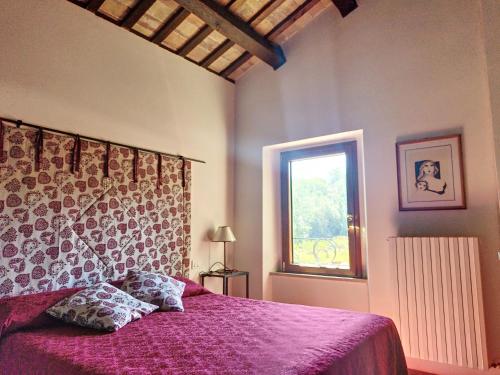 Agriturismo la Casa del Vecchio Mulino tesisinde bir odada yatak veya yataklar