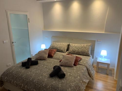 a bedroom with a large bed with pillows on it at LA PICCOLA MAGIA in Pisa