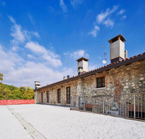 an old stone building with two chimneys on top of it at Agriturismo Cascina Mirandola in Como