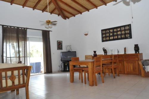a dining room and living room with a table and chairs at Appartement à Saly in Saly Portudal