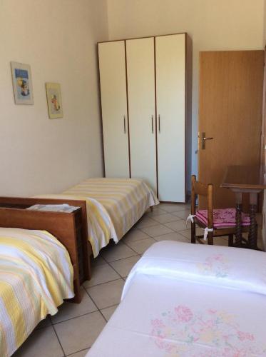 a bedroom with two beds and a table and a desk at Agriturismo Susanna e Atria in Bibbona