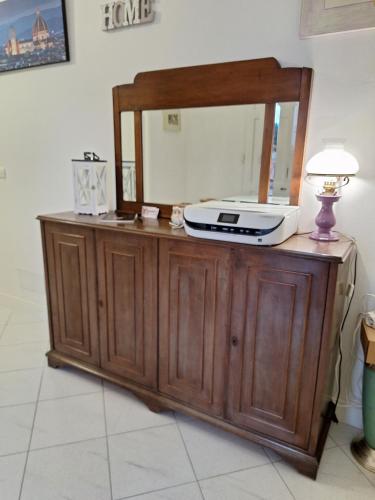 a mirror on top of a dresser with a radio on it at Giada Apartment in Calenzano