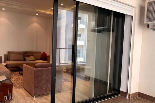 a living room with a sliding glass door at Appartement luxueux in Tunis