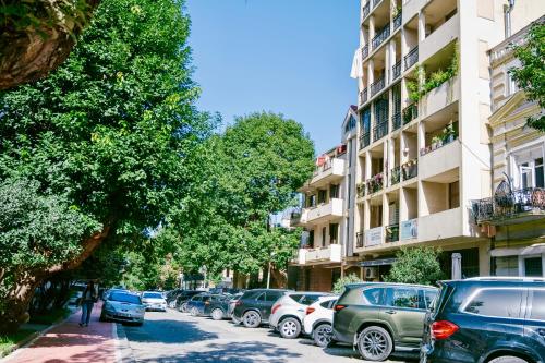 una fila de autos estacionados al lado de una calle en Ekaterine's Apartments, en Batumi