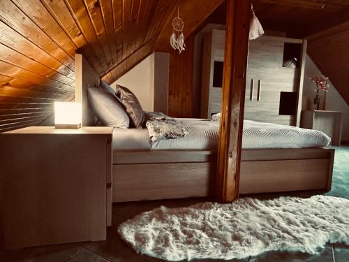 a bedroom with a canopy bed with a rug at Apartman Tóth György in Bačka Topola